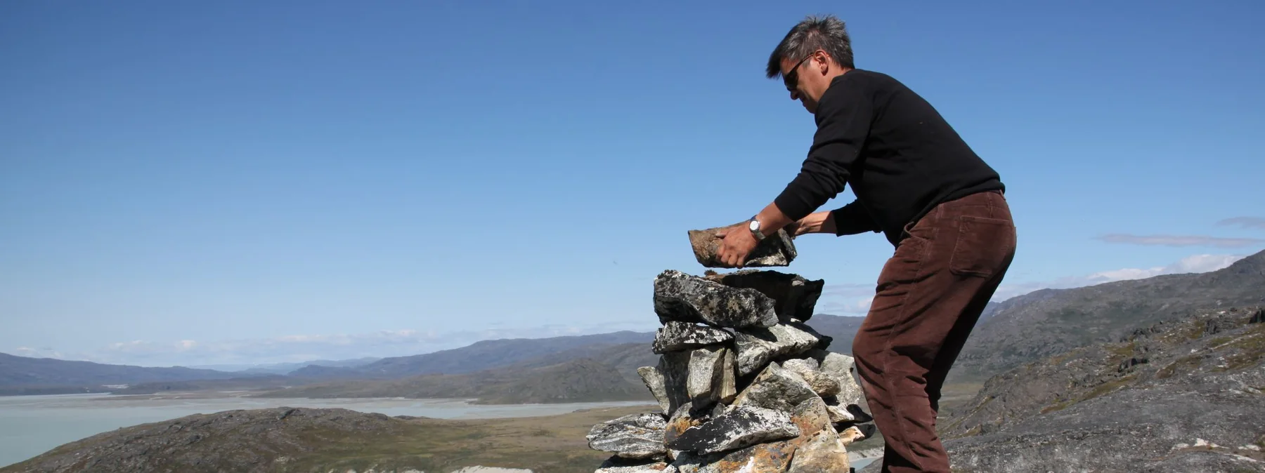 Poul Bloch Jensen building a cairn in Greenland